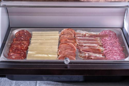 a tray of meats and other meats and cheese at Hotel VIDA Mar de Laxe in Laxe