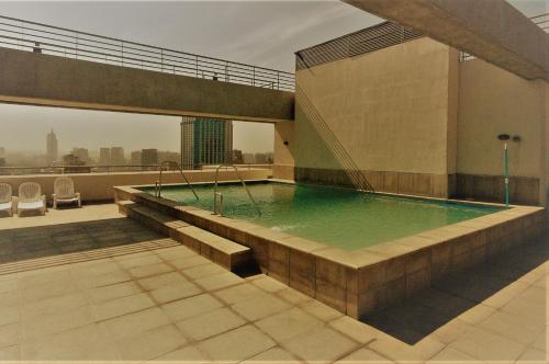 a swimming pool on the roof of a building at Personal Aparts Bellas Artes in Santiago