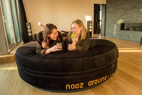 two girls are sitting in a bean bag chair at Exclusieve privé wellness penthouse SkyNooz in Antwerp