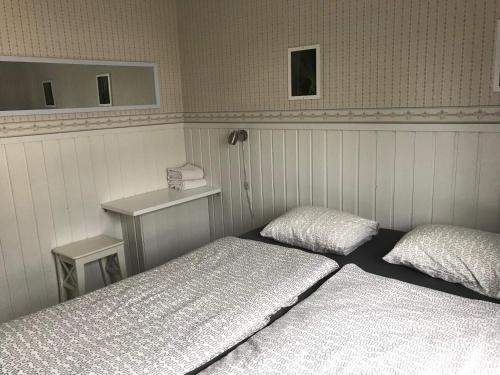 a hotel room with two beds and two lamps at Guesthouse Borealis in Rovaniemi