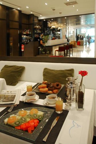 a table with a tray of food on it at Grupotel Gran Via 678 in Barcelona