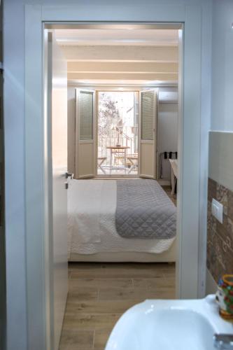 a view of a bedroom with a bed through a door at Vento di Sicilia in Siracusa