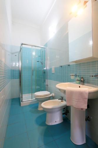 a bathroom with a sink and a toilet and a shower at Villa Mele in Lido Marini