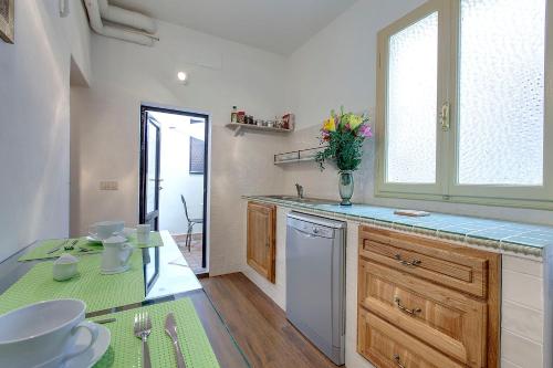 a kitchen with a counter and a sink and a window at Palazzo Bucciolini in Florence