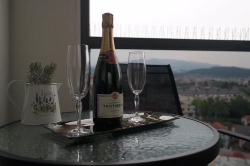 a bottle of champagne and two wine glasses on a table at Studio apartman Anamaria in Zagreb