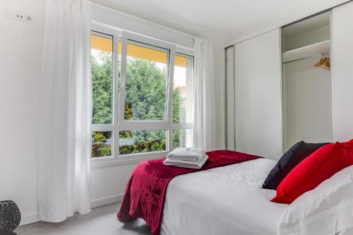 a white bedroom with a bed and a window at Rueiro 17 in A Coruña