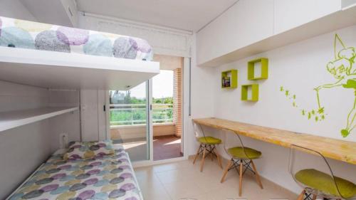 a room with a bunk bed and a desk and chairs at Apartaments Cambrils Suite Costa Daurada in Cambrils