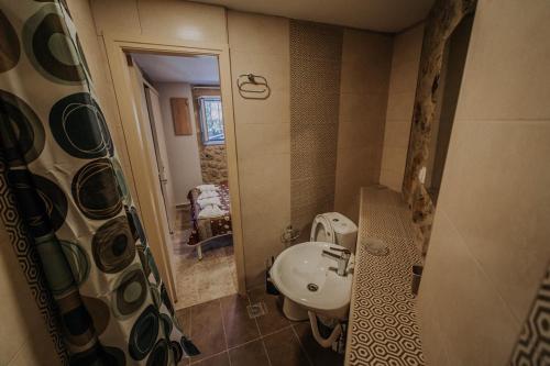 a small bathroom with a sink and a shower at Eleutheria in Kalamata