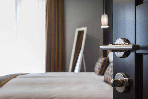 a close up of a bedroom door with a bed at Resort Hotel Elija in Šventoji