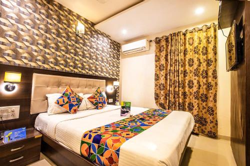 a hotel room with a bed and a window at Hygienic Hotel Liberty Plaza in Mumbai