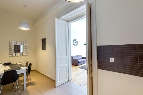 a door leading into a dining room with a table at Luxury & Panorama Apartments in Budapest