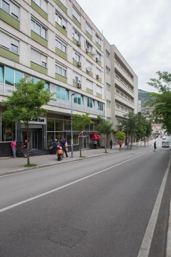 an empty street in front of a large building at Luxury Studio Yasmine in Mostar