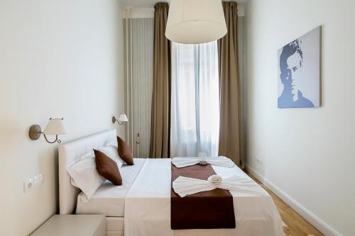 a hotel room with a bed with a bow on it at Luxury & Panorama Apartments in Budapest