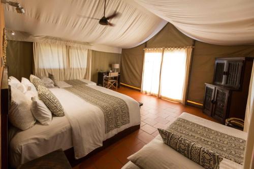 a bedroom with two beds and a couch in it at Zaina Lodge in Mole