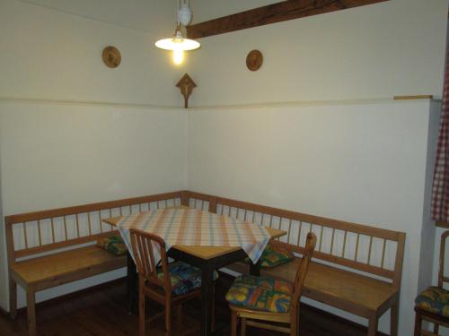 a table and chairs in a room with a table and a table and chairsktop at Schloss Manndorf Gästehaus in Kötschach
