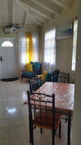 a living room with a dining room table and chairs at Spacious Colonial in Bridgetown