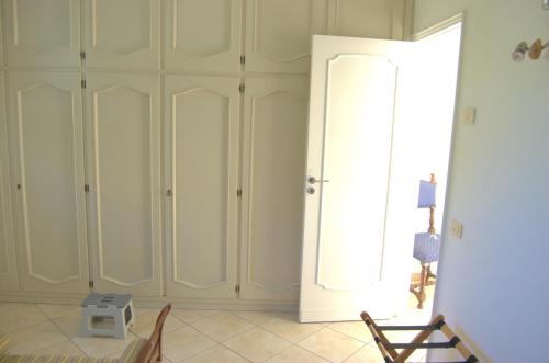 a room with white cabinets and a window at La Terrazza sul Mare in Capri