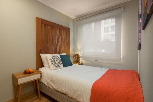 a small bedroom with a bed and a window at Casa Bellavista Hotel in Santiago