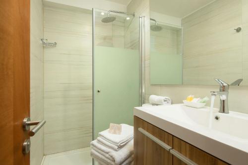 a bathroom with a sink and a shower at Casa Bellavista Hotel in Santiago