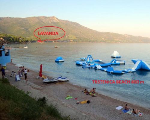 a group of people on a beach with water slides at Lavanda Mobile Homes & Villas in Orebić