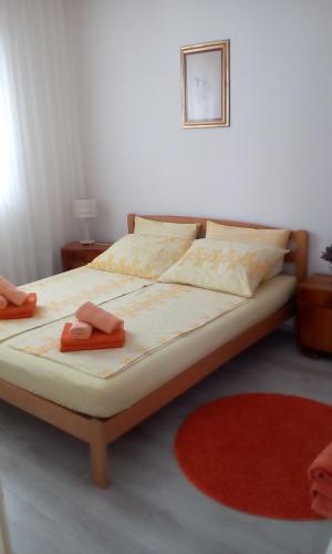 a bedroom with a bed with two towels on it at Apartman Zana in Vodice