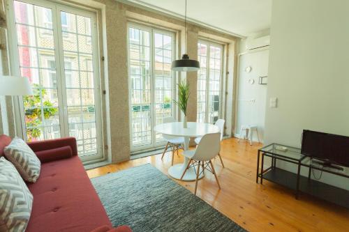 a living room with a couch and a table at Oporto City View - Santo Ildefonso in Porto