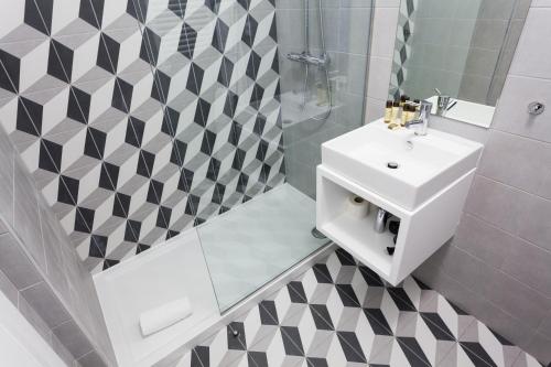 a bathroom with a white sink and a shower at Oporto City View - Santo Ildefonso in Porto