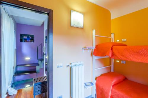 a room with two bunk beds and a doorway at Case Spazioscena - Euterpe in Castelbuono