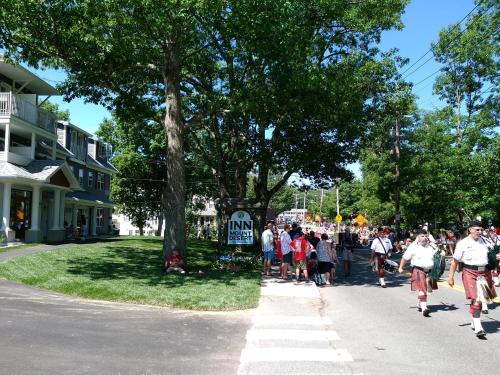 a crowd of people walking down a street at The Inn on Mount Desert in Bar Harbor