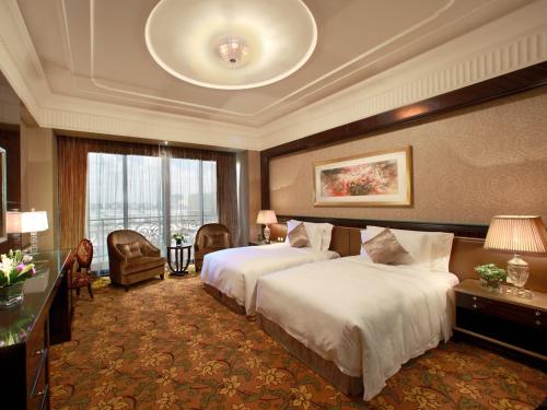 a hotel room with two beds and a large window at Chateau Star River Pudong Shanghai in Shanghai