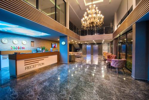 a lobby of a hotel with a reception desk and chairs at White House Hotel in Trabzon