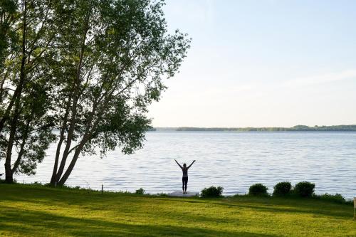 a person standing in front of a body of water at Designhotel Whitman in Ascheberg