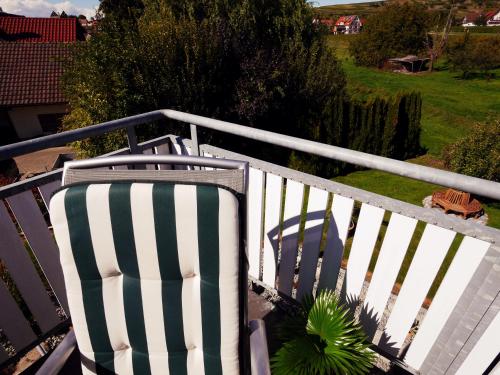 a white and green fence with a plant on it at Kreuz-Post Hotel-Restaurant-SPA in Vogtsburg