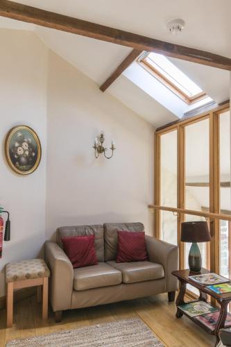 a living room with a couch and a window at The Barn B&B in Margam