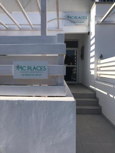 a building with a sign that says msg places on it at MCPlaces Holiday Apartments in Paphos City