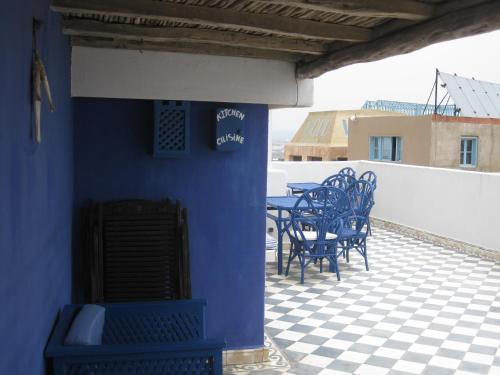 a group of blue tables and chairs on a patio at Dar Al Bahar in Essaouira