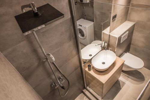 a bathroom with a toilet and a sink and a shower at BCAdria apartments in Split