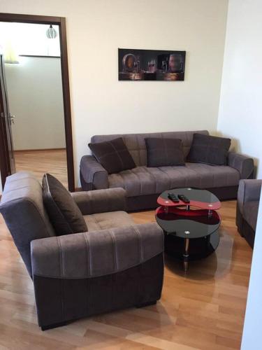 a living room with a couch and a coffee table at Asterias Apartment in Tbilisi City