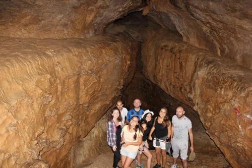 a group of people standing in a cave at Racha guest house MERO in Ambrolauri