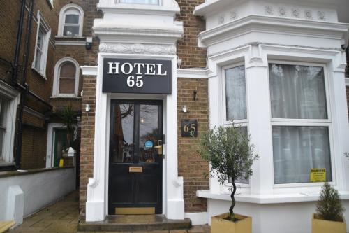a hotel sign on the front of a building at Hotel 65 in London