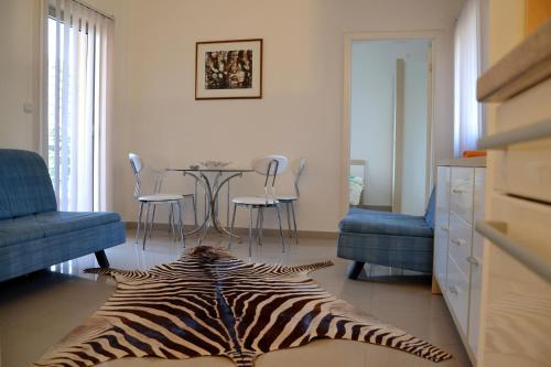 a zebra rug on the floor of a living room at Montesun Residence in Herceg-Novi