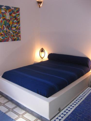 a bed in a room with a blue mattress at Dar Al Bahar in Essaouira