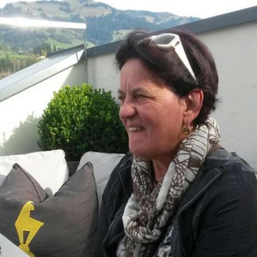 a woman with a headband on her head sitting on a couch at Landhaus Greiderer in Kössen