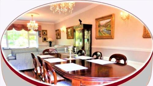 a dining room with a table and chairs and a mirror at Leabrook House in Castlemaine