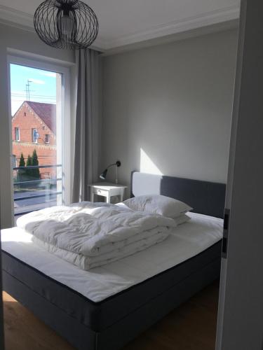 Posteľ alebo postele v izbe v ubytovaní Apartamenty centrum Augustów