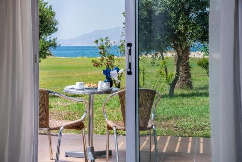 a table and chairs on a patio with a view of the ocean at Gaia Royal in Mastichari