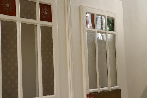 two windows in a room with white walls at OPERA Hostel in Erfurt