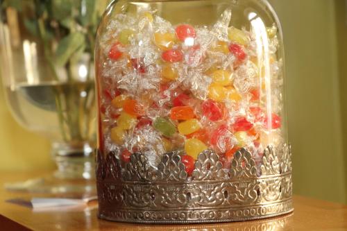 a glass jar filled with candy on a table at OPERA Hostel in Erfurt