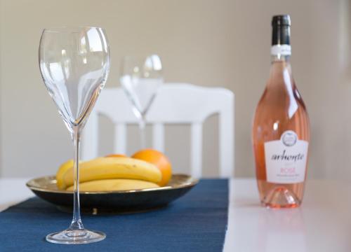 a bottle of wine and a plate of fruit and a glass at Vasiliki in Virpazar