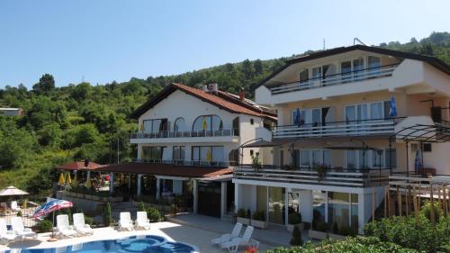 a large building with a swimming pool in front of it at Villa Angelos in Ohrid